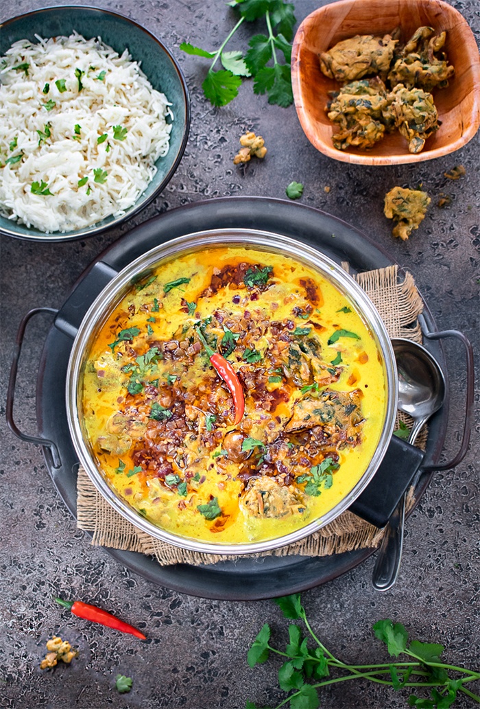 Punjabi Kadhi pakora garnished with red chili on top