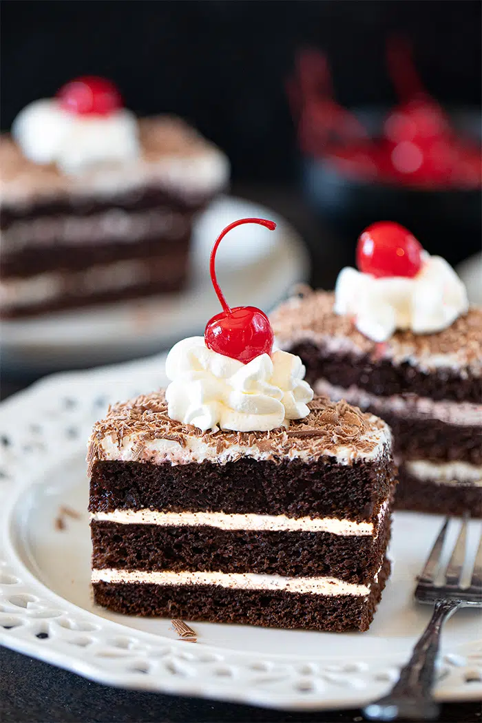 Eggless Black forest Pastry topped with whipped cream and cherry