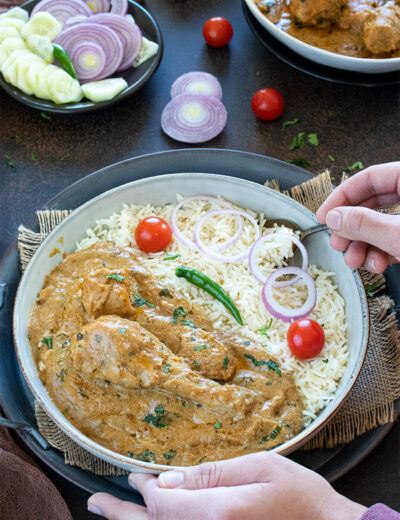 Mughlai Chicken served with rice and onions