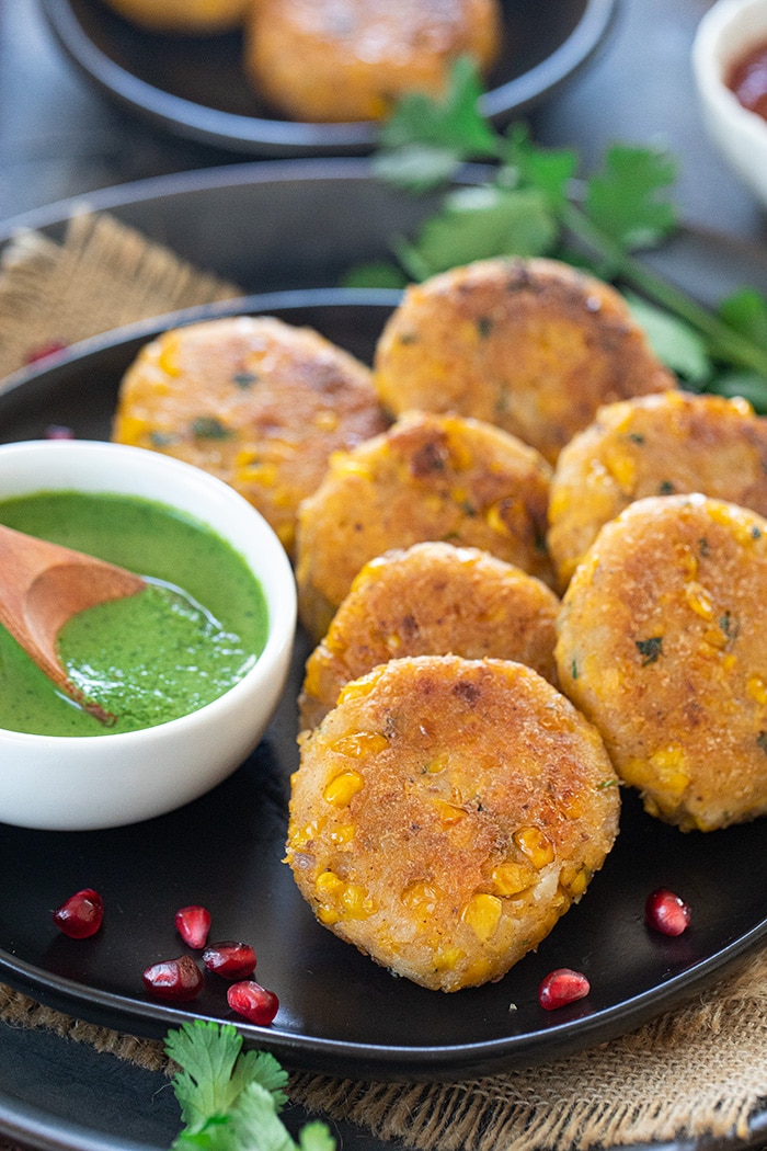 Corn kebad on a plate with chutney 
