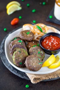 Hara Bhara Kabab served with ketchup on a plate