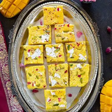 Mango Kalakand in a tray with diya