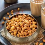 Achari Masala Peanuts with tea in a bowl