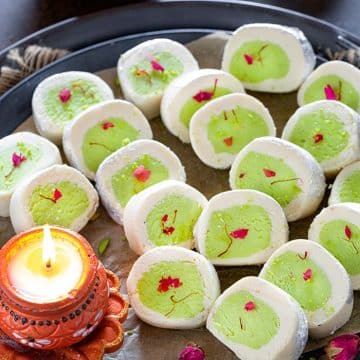Pista Mithai roll with diya on a plate