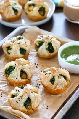 Palak Paneer puffs garnished with black sesame seeds