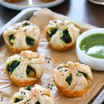 Palak Paneer puffs garnished with black sesame seeds