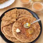 Onion and Besan Paratha served with achar and curd