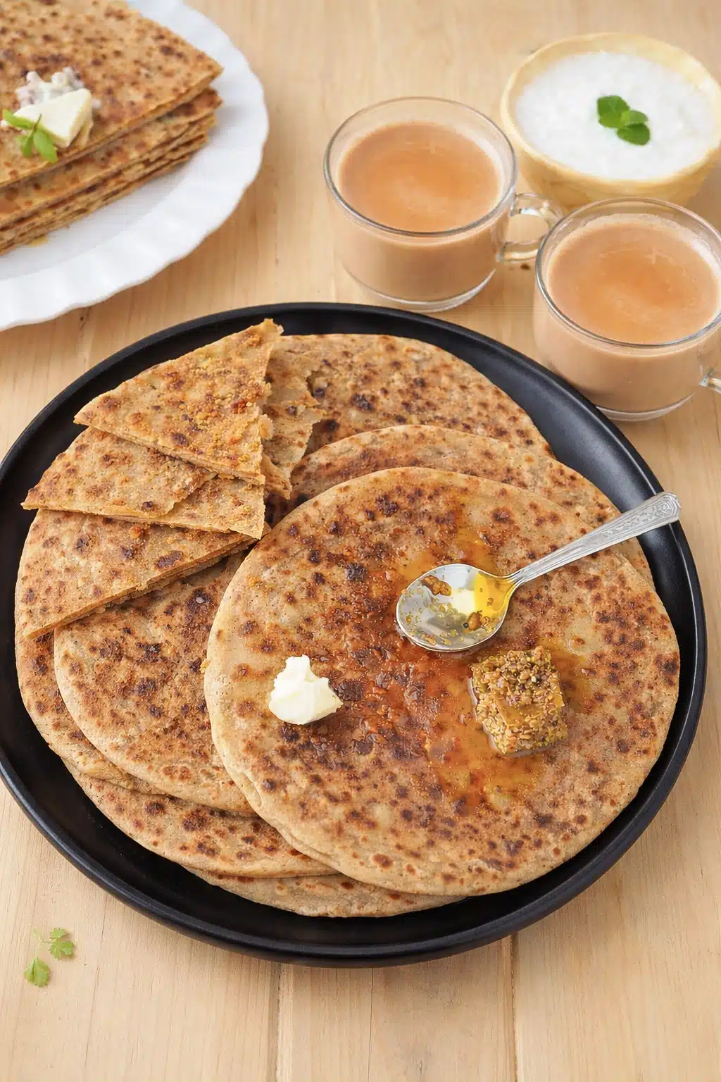 Onion and Besan Paratha served with achar and curd