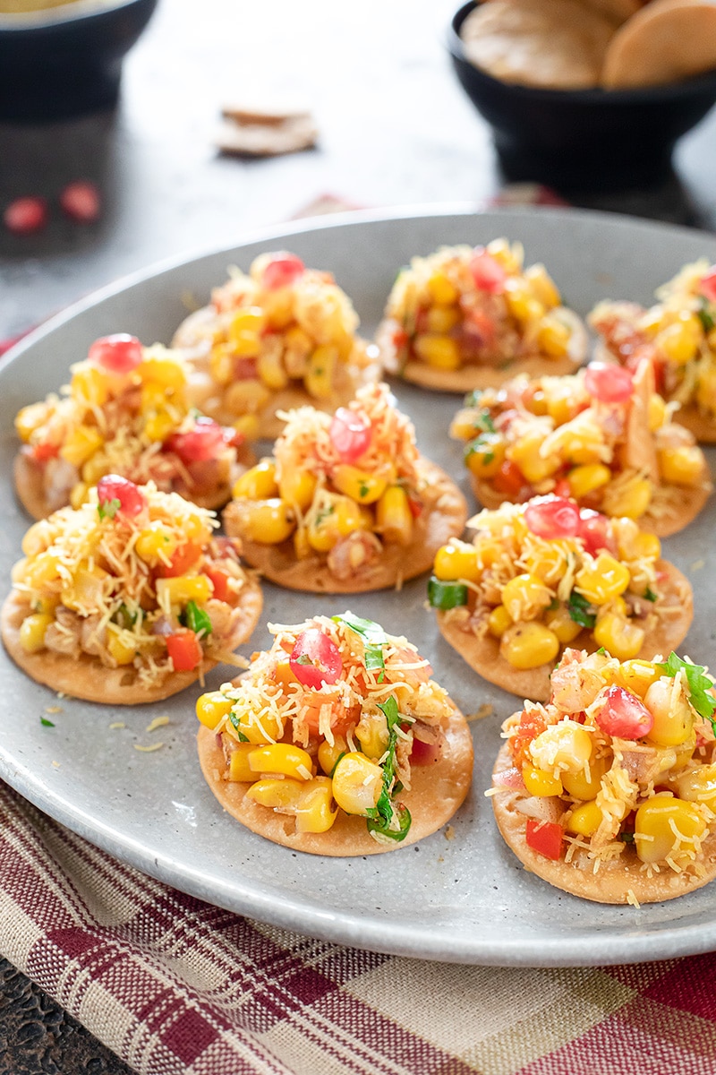 Corn Masala Chaat spread on papadis